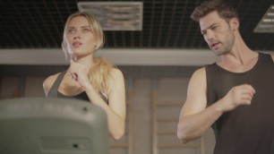 'concentrated sport couple talking in fitness gym fitness woman and man training'