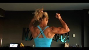 'Muscular Fitness Woman flexing her powerful steel ripped biceps'