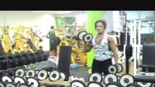 'Fitness Woman intense Bicep workout in Gym'