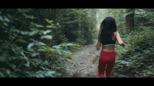 'Fitness woman jogging down a forest path- Free Stock Footage'
