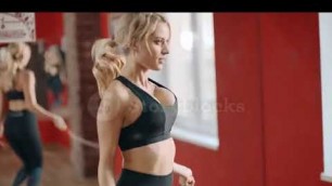 'videoblocks sexy fitness woman jumping on skipping rope in gym pretty girl training jump exercise wi'