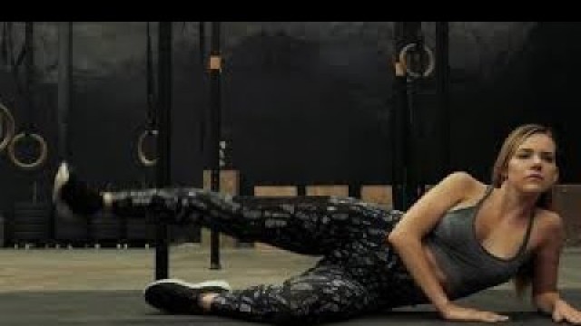 'fitness woman doing side plank leg raise exercises'