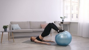'fitness woman exercising with fitball lying on flo SDWMZKR'